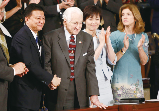 Retired U.S. Marine and Iwo jima survivor Snowden greets Japanese Diet member Shindo prior to Japanese Prime Minister Abe's address to a joint meeting of Congress on Capitol Hill in Washington